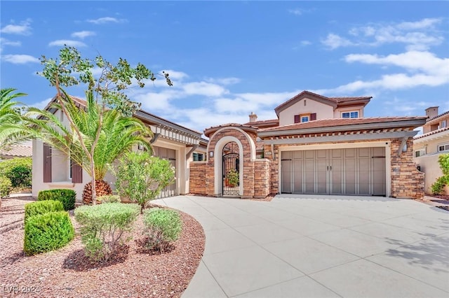 mediterranean / spanish house with a garage