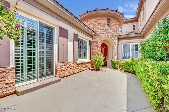 entrance to property with a patio