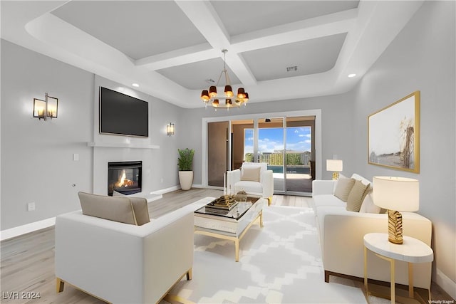 living room featuring beam ceiling, light wood-type flooring, coffered ceiling, and a notable chandelier