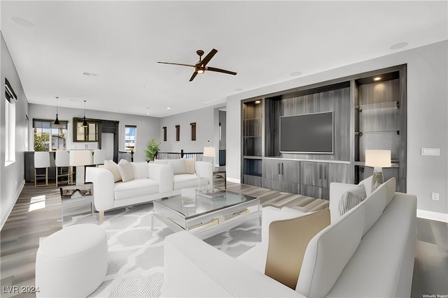 living room with ceiling fan and hardwood / wood-style floors