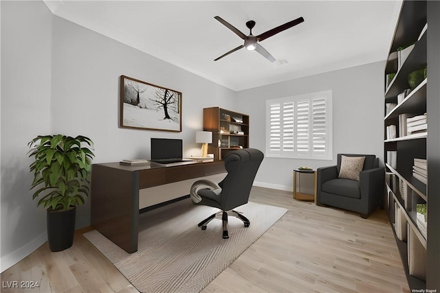 office with ceiling fan and light hardwood / wood-style floors