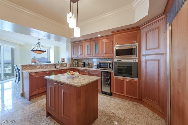 kitchen featuring pendant lighting, crown molding, appliances with stainless steel finishes, a kitchen island, and beverage cooler