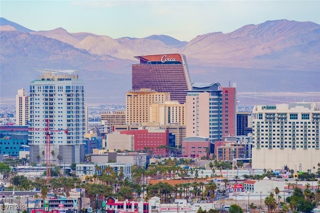 property's view of city featuring a mountain view