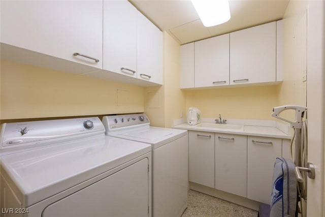 clothes washing area with cabinets, independent washer and dryer, and sink