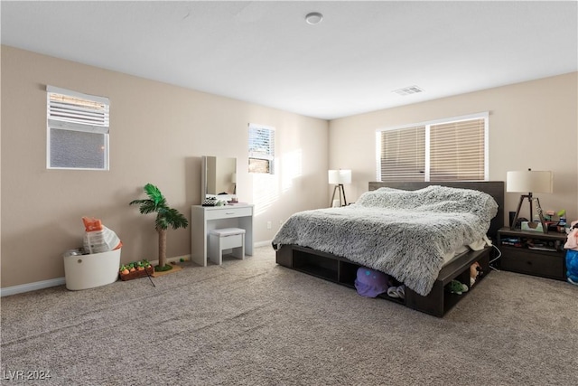 carpeted bedroom featuring multiple windows