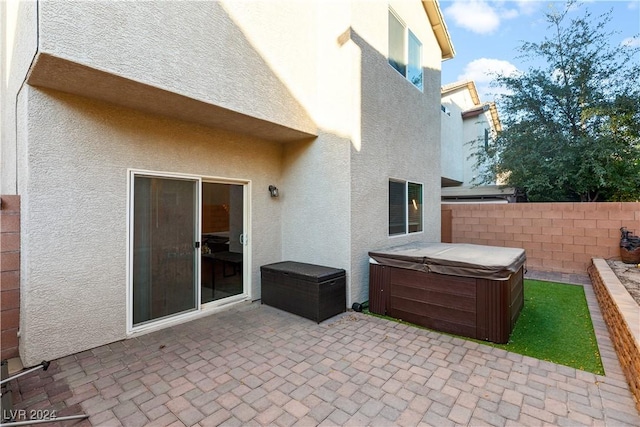 view of patio / terrace with a hot tub