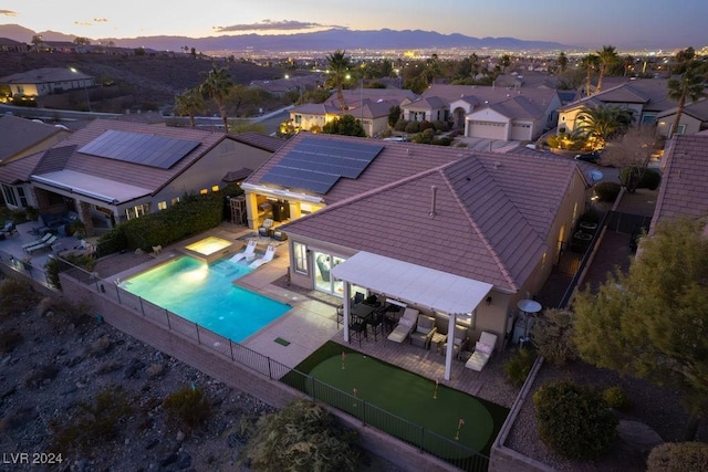 aerial view at dusk featuring a mountain view