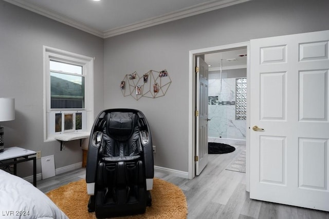 bedroom featuring crown molding, ensuite bath, and light hardwood / wood-style floors