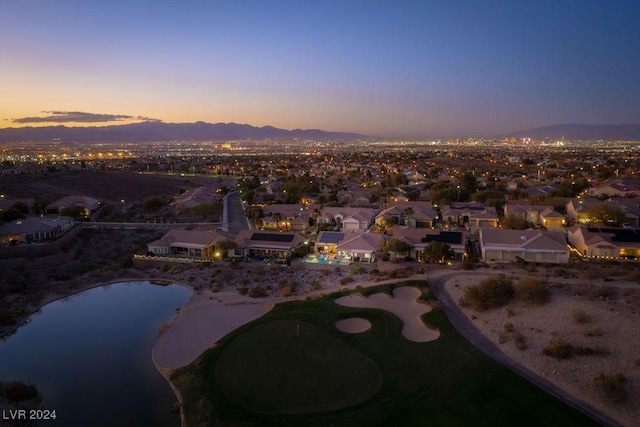 aerial view at dusk with a water view