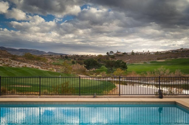 view of swimming pool with a mountain view