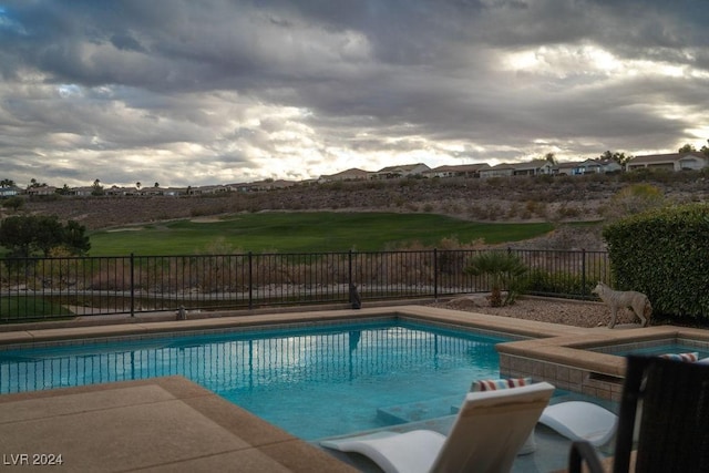 view of swimming pool featuring an in ground hot tub