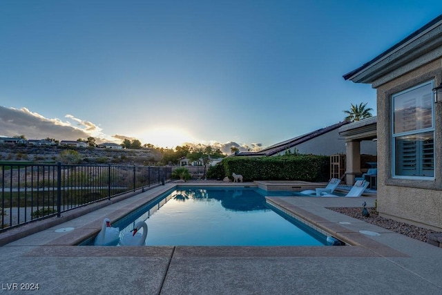 view of pool at dusk