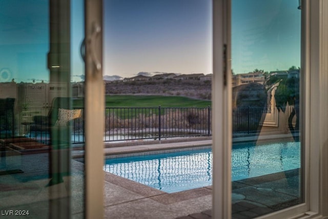 view of pool at dusk