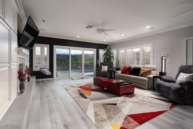 living room featuring ceiling fan, ornamental molding, and light hardwood / wood-style floors