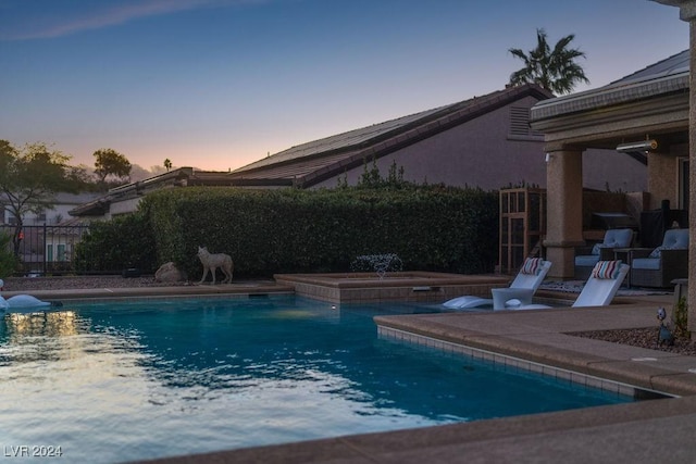 view of pool at dusk