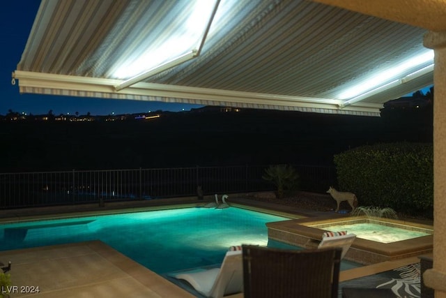 view of pool at night