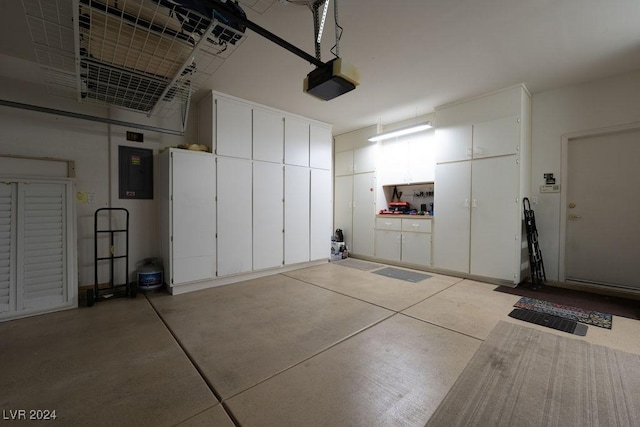 garage featuring a garage door opener and electric panel