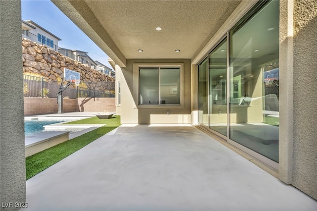 view of patio / terrace with a fenced in pool