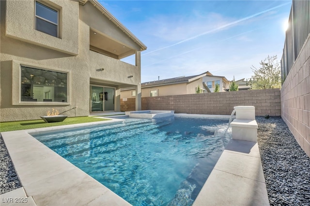 view of pool with an in ground hot tub and pool water feature