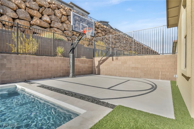 view of basketball court featuring a fenced in pool