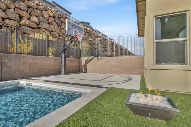 view of basketball court with a fenced in pool