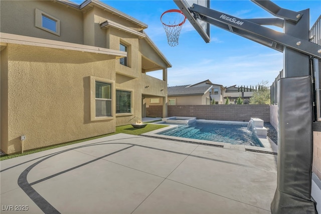 view of swimming pool with an in ground hot tub and a patio