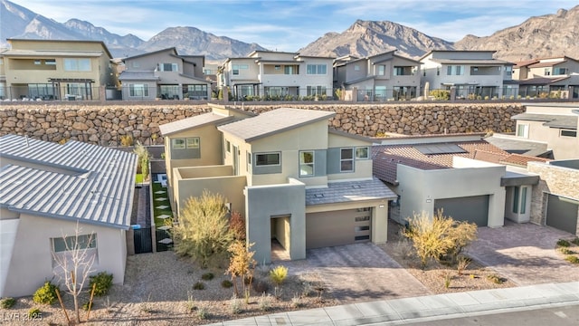 view of front of property featuring a garage and a mountain view