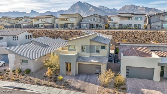 multi unit property featuring a mountain view and a garage