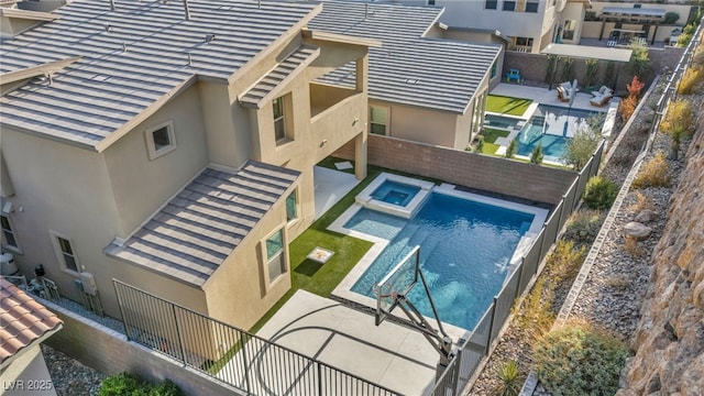 view of pool featuring a patio area and an in ground hot tub