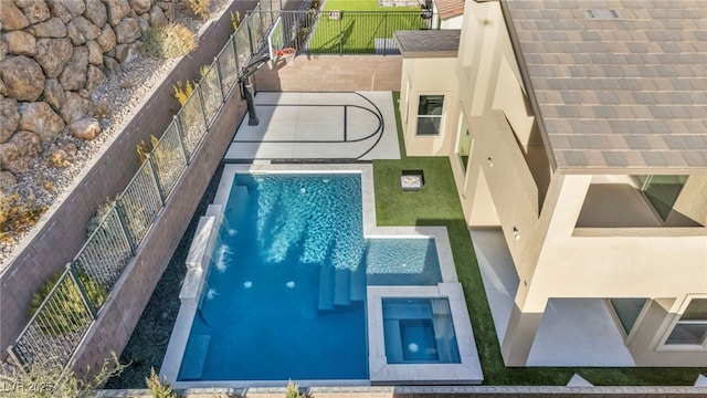 view of swimming pool featuring an in ground hot tub