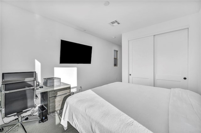 carpeted bedroom featuring a closet