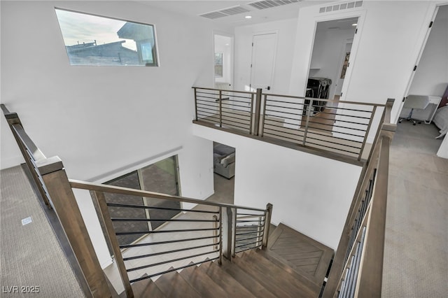 stairs featuring wood-type flooring