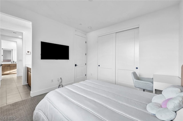 bedroom with light tile patterned flooring and a closet