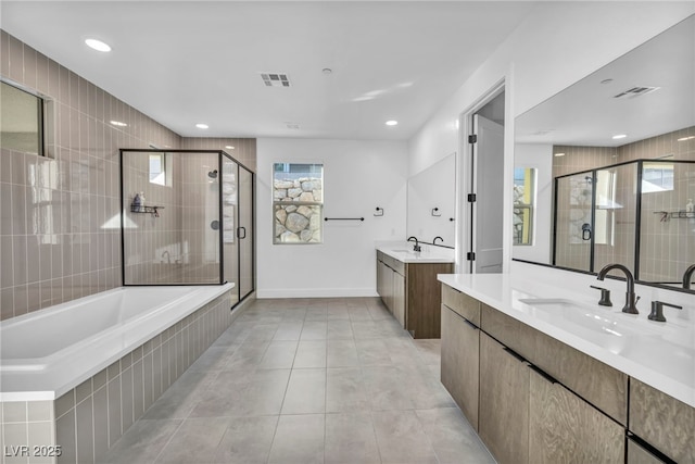 bathroom with vanity, plus walk in shower, and tile patterned flooring