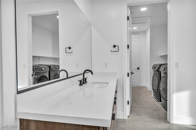 bathroom featuring vanity and washer and dryer