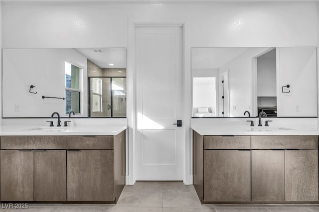 bathroom featuring tile patterned flooring, vanity, and a shower with shower door