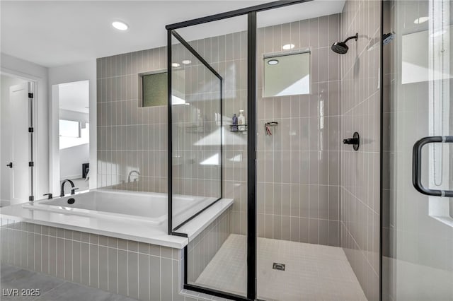 bathroom with tile patterned floors and separate shower and tub