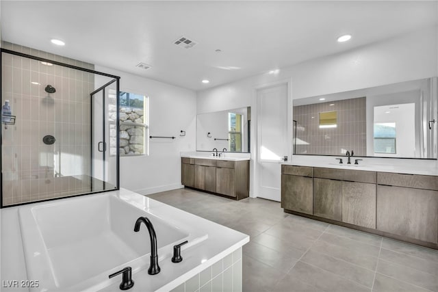 bathroom featuring vanity, tile patterned flooring, and shower with separate bathtub