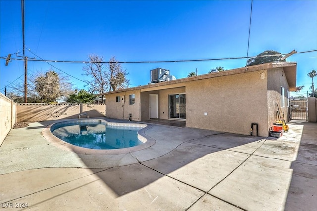 view of swimming pool with a patio and central AC unit