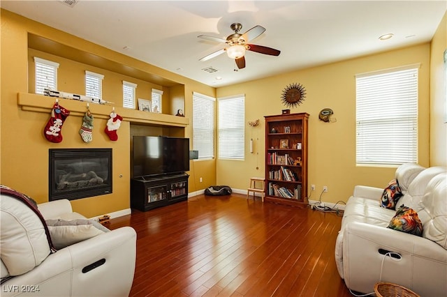 living room with ceiling fan and dark wood-type flooring