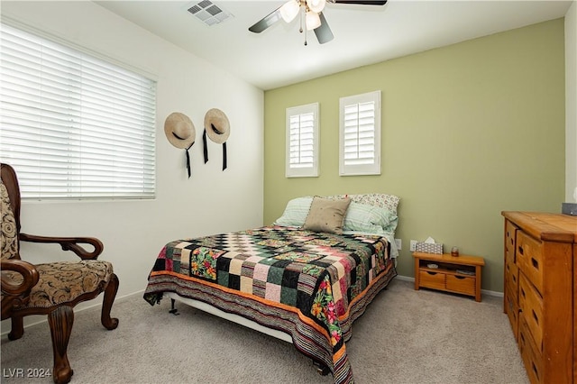 bedroom featuring ceiling fan and light colored carpet