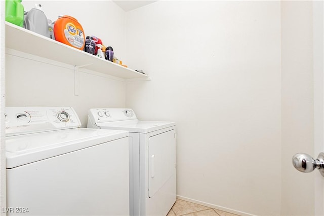 clothes washing area with light tile patterned floors and washing machine and clothes dryer