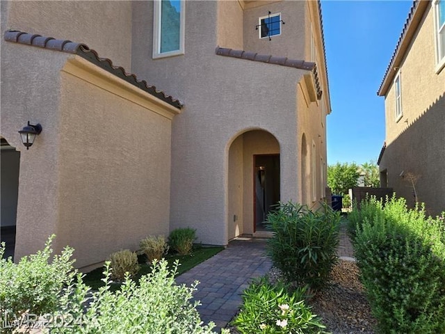 entrance to property featuring a patio area