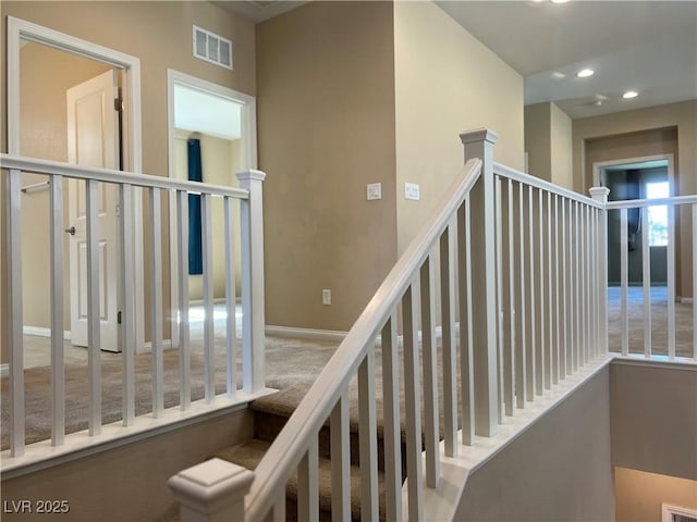 stairway featuring baseboards, visible vents, and recessed lighting