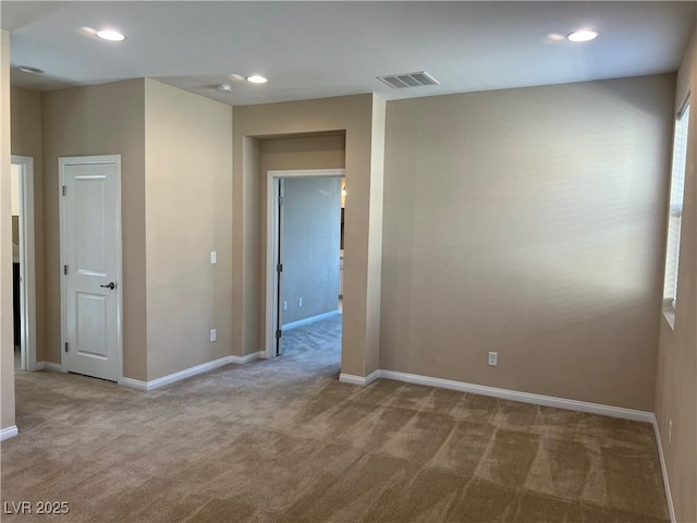 carpeted spare room with recessed lighting, visible vents, and baseboards