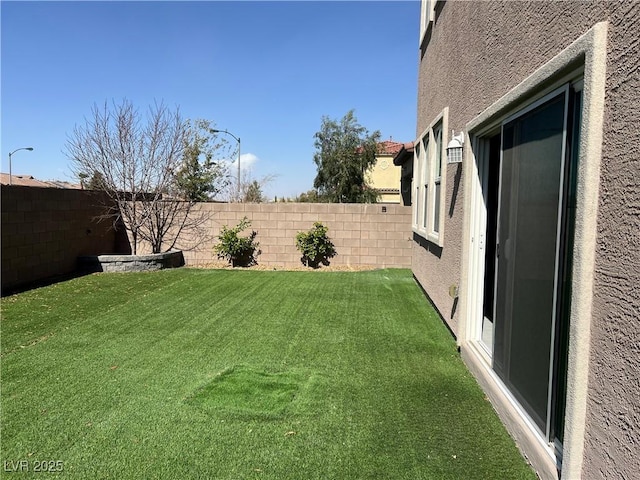 view of yard with a fenced backyard