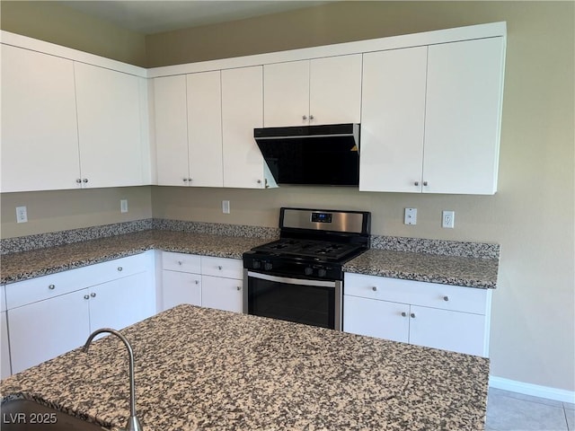 kitchen with exhaust hood, gas range, and white cabinetry