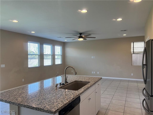 kitchen featuring light tile patterned floors, appliances with stainless steel finishes, white cabinetry, a sink, and recessed lighting