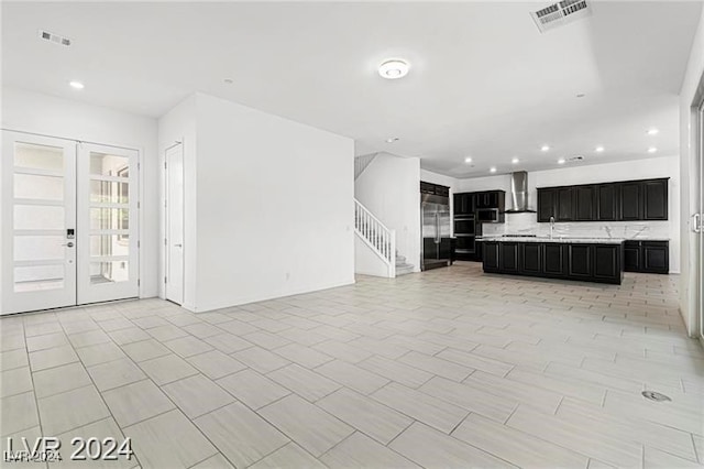 unfurnished living room featuring french doors