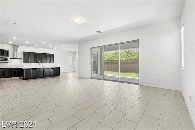 unfurnished living room with sink